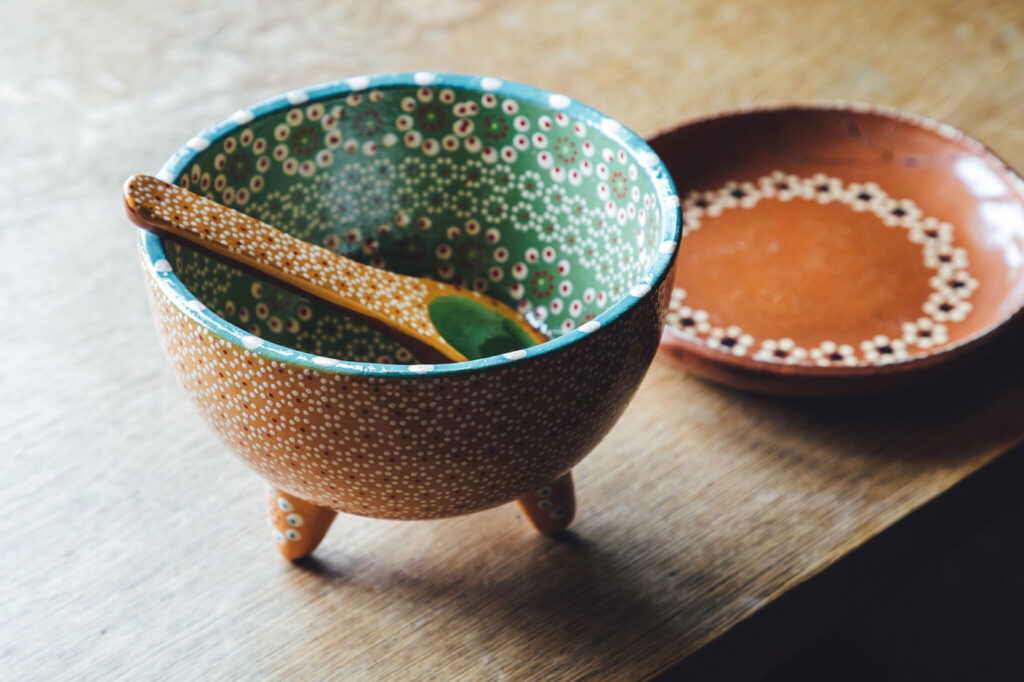 アボカドの産地・ミチョアカン州のカプラ村は古くから作陶が盛んな土地。繊細なドットで模様を描くカプラ焼き。モロカヘテ（すり鉢）を模した色鮮やかな器や、シンプルな絵付けの平皿など、個性豊かなデザインを楽しんで。