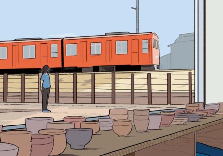 セレクトショップ『POTOMAK』からは、線路を走るご当地列車のオレンジ色の車両を望むことができる。