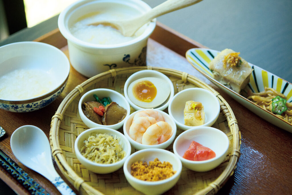 海老や鮑、ふりかけ状の魚鬆など、7種の具材が付いた台湾式朝ごはんのお粥。惣菜やフルーツ、豆花とともに。