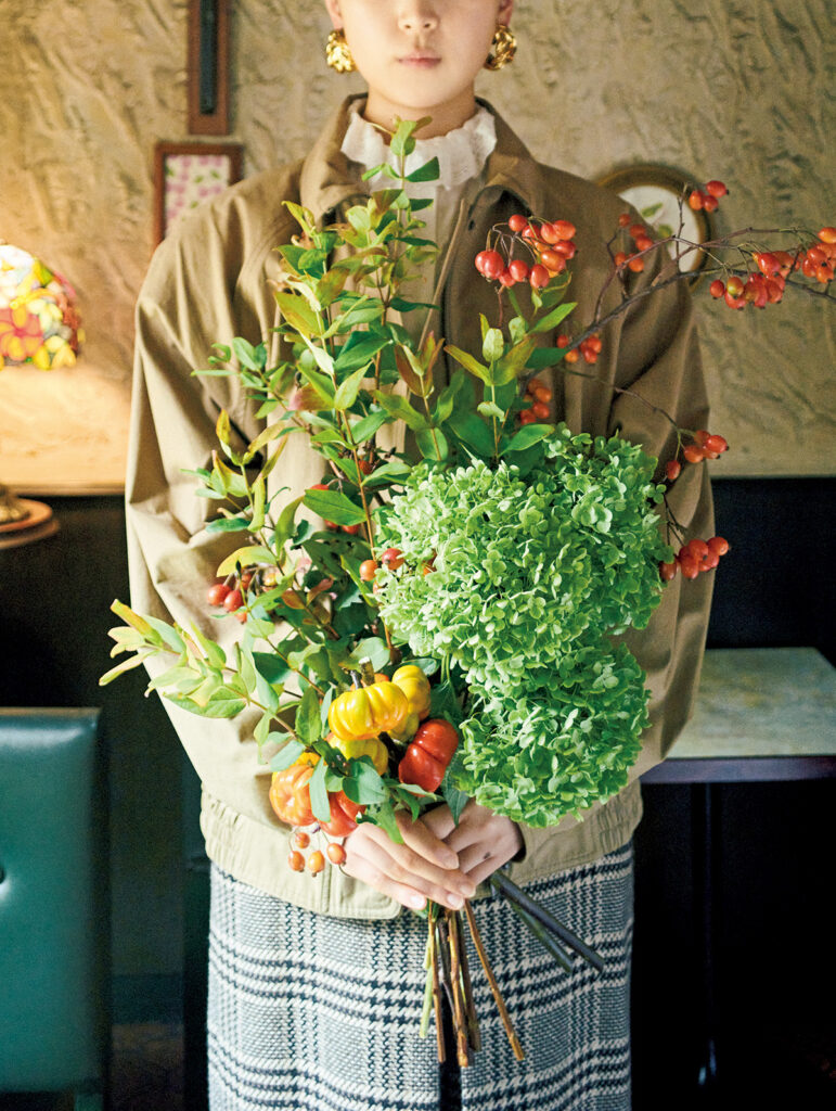 枝先に小さなオレンジの実をぶら下げたスズバラ